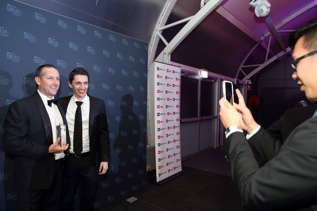 Aaron Links & Chris White proudly taking a photo with one of the awards