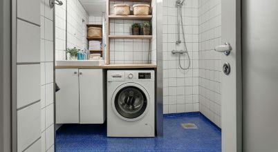 A small laundry and shower room has space for only one laundry machine, a washer dryer combo