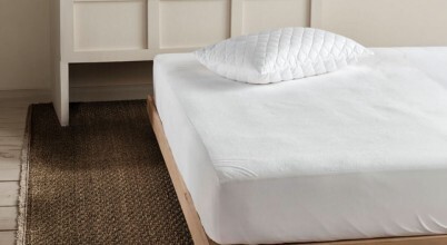 A mattress with a mattress protector on it