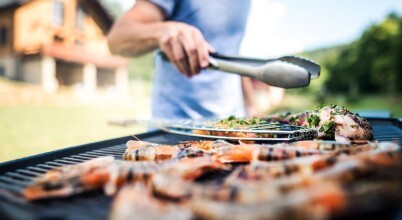 Close-up of a man barbecuing prawns and chicken