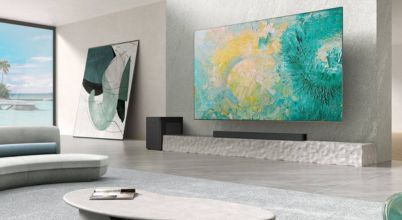 A TCL brand soundbar, subwoofer and large screen TV in a contemporary home