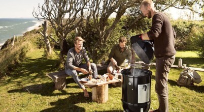 Men using a Weber brand smoker