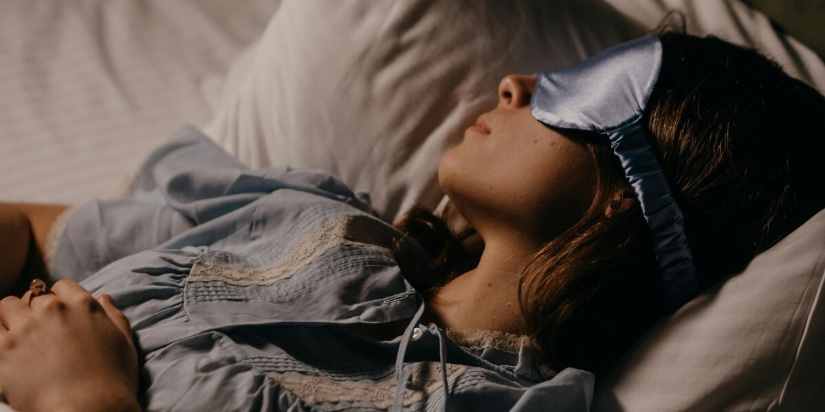 A woman sleeping wearing an eye mask