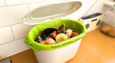 A FOGO - Food Organics Garden Organics - kitchen caddy full of fruit, vegetable and other food scraps for composting in a council facility