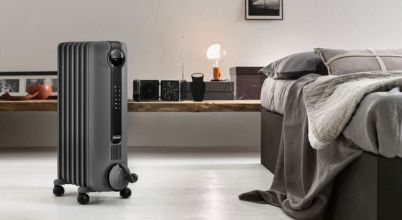 A Delonghi brand column heater in a bedroom