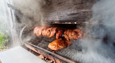 Slow-cooked chickens on a smoker BBQ